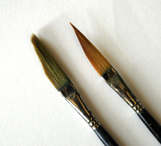 Two similar paintbrushes, one cleaned with brush cleaner.